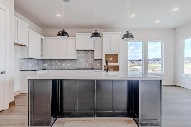 141 Peninsula Point Dr, Montgomery, TX 77356 - kitchen featuring a sink, backsplash, light wood finished floors, white cabinetry, and recessed lighting
