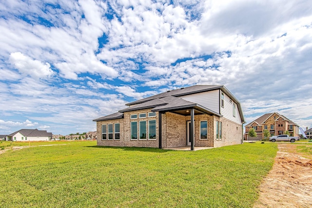 141 Peninsula Point Dr, Montgomery, TX 77356 - back of house with brick siding, a yard, and a patio area