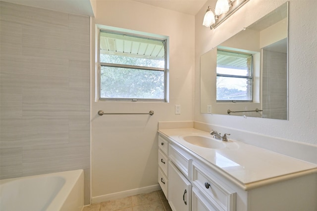 full bath with vanity, baseboards, and tile patterned floors