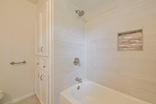 full bath featuring tile patterned flooring, baseboards, and shower / tub combination