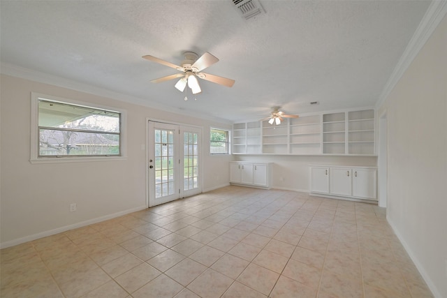 unfurnished room with baseboards, visible vents, a textured ceiling, and ornamental molding