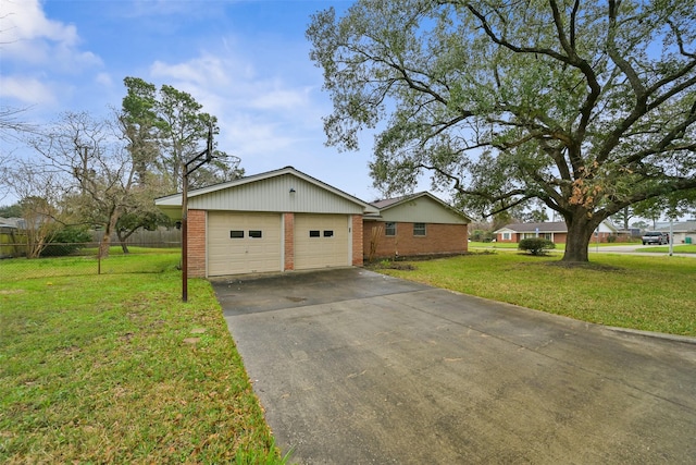 view of front of home featuring a garage, brick siding, a front yard, and fence