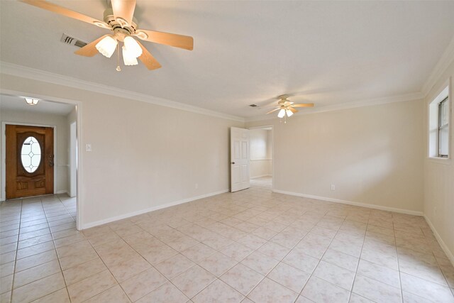 spare room with ornamental molding, a wealth of natural light, visible vents, and light tile patterned floors