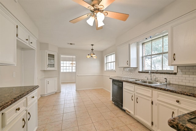 kitchen featuring a sink, tasteful backsplash, white cabinetry, and dishwasher