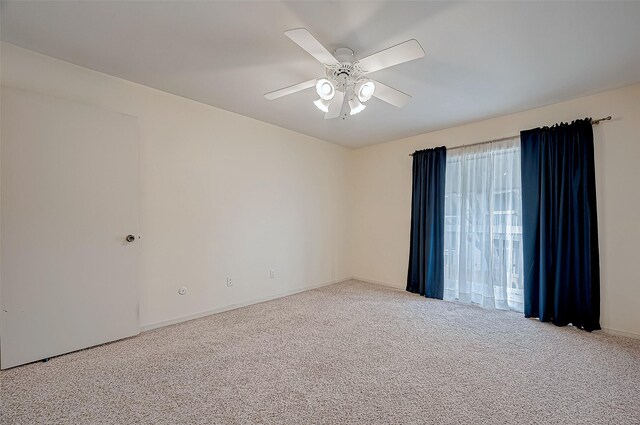 unfurnished room with carpet floors and a ceiling fan