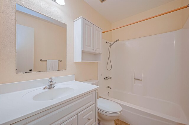 bathroom featuring tub / shower combination, vanity, and toilet