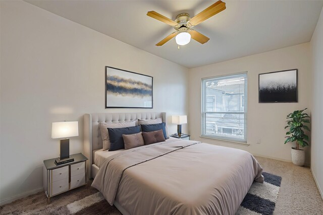 carpeted bedroom featuring ceiling fan and baseboards