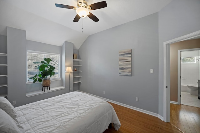 bedroom featuring vaulted ceiling, wood finished floors, a ceiling fan, and baseboards