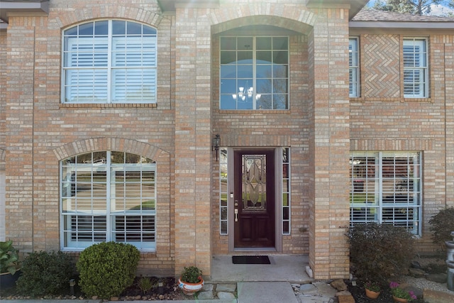 entrance to property featuring brick siding