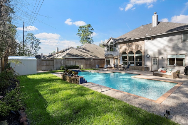view of swimming pool featuring a fenced in pool, a lawn, an outdoor hangout area, a patio area, and a fenced backyard