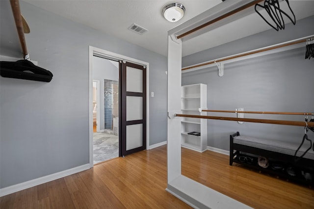spacious closet with visible vents and wood finished floors