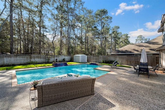 view of swimming pool with a fenced in pool, a patio, a storage unit, a fenced backyard, and an outdoor structure