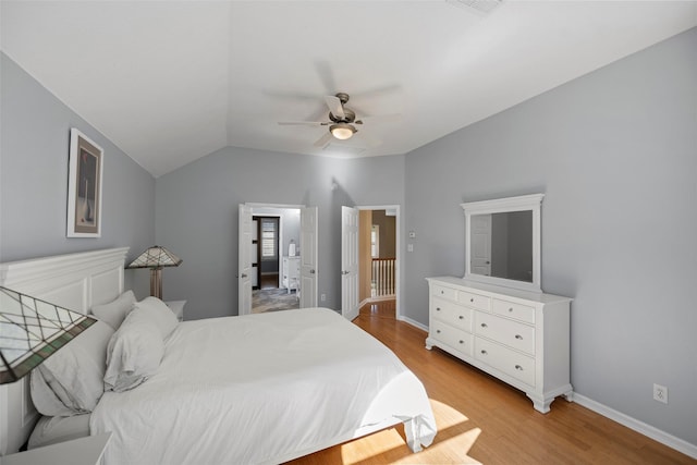 bedroom featuring vaulted ceiling, a ceiling fan, light wood-style flooring, and baseboards