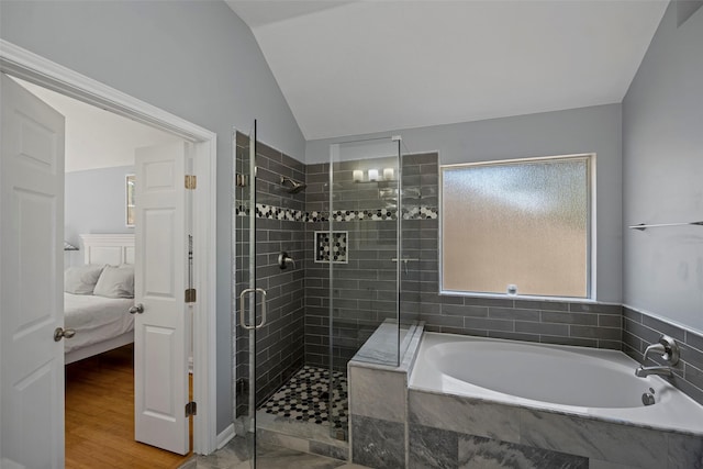bathroom featuring lofted ceiling, a stall shower, connected bathroom, wood finished floors, and a bath