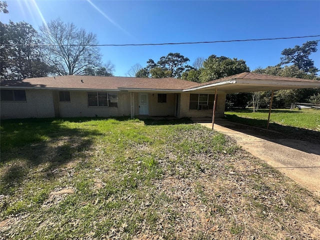 view of front facade with driveway, a front lawn, an attached carport, and brick siding