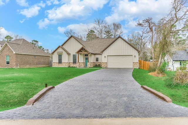 view of front of property featuring board and batten siding, a front lawn, fence, decorative driveway, and stone siding