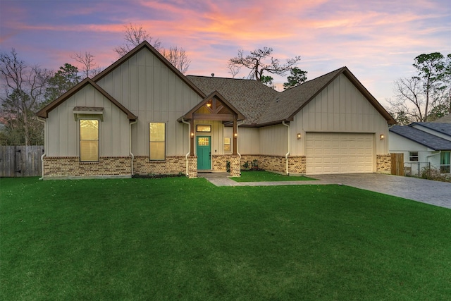 view of front of home featuring an attached garage, decorative driveway, a yard, and fence