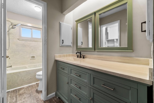 full bathroom featuring toilet, tub / shower combination, a textured ceiling, vanity, and wood finished floors