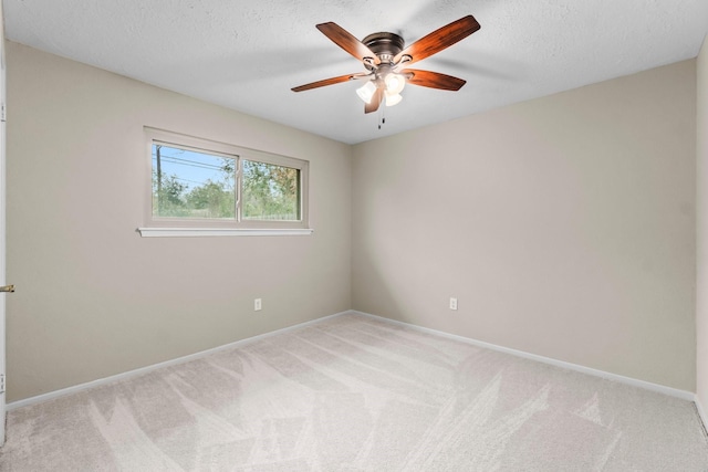 unfurnished room with light carpet, a textured ceiling, and baseboards