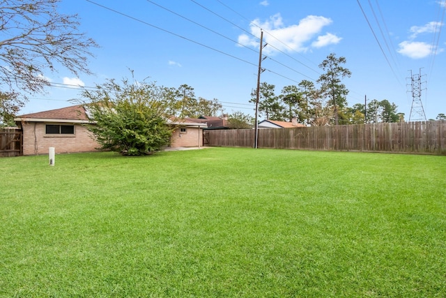 view of yard with a fenced backyard