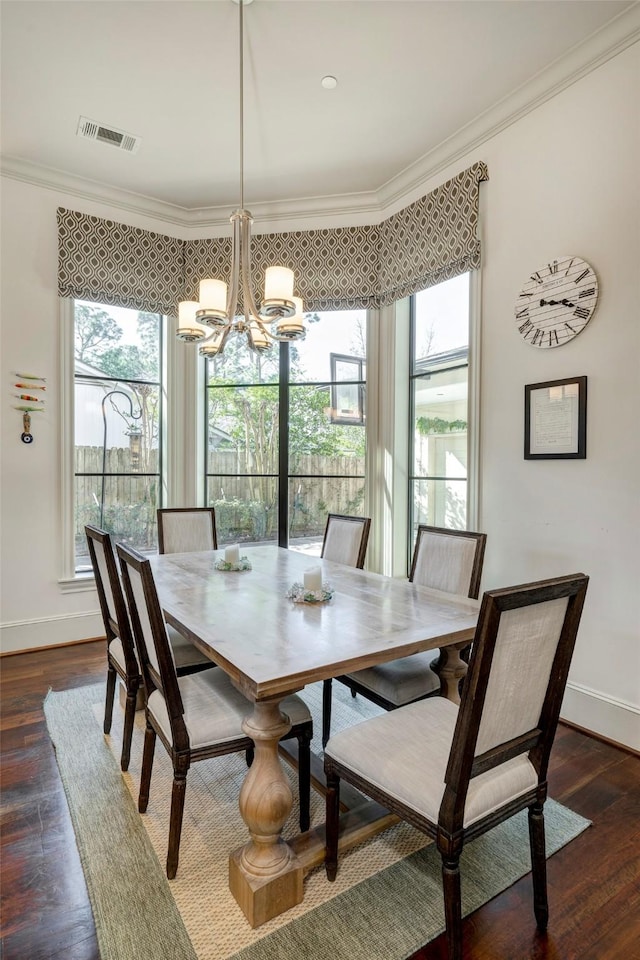 dining room with visible vents, plenty of natural light, a notable chandelier, and crown molding