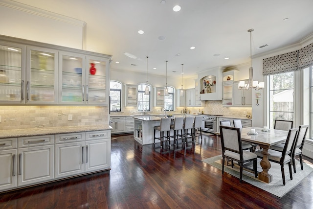 dining room featuring dark wood finished floors, visible vents, recessed lighting, and crown molding