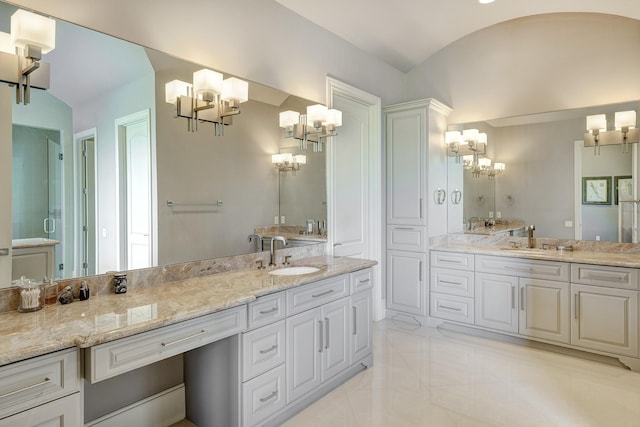 bathroom with vanity and a notable chandelier