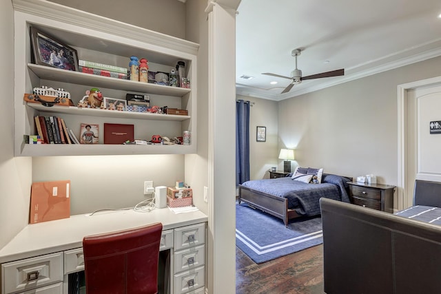 bedroom featuring dark wood-type flooring, built in desk, and ornamental molding