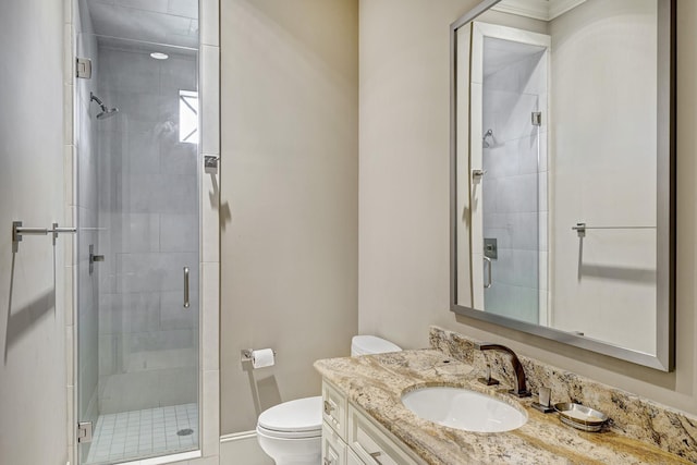 bathroom with vanity, toilet, and a shower stall