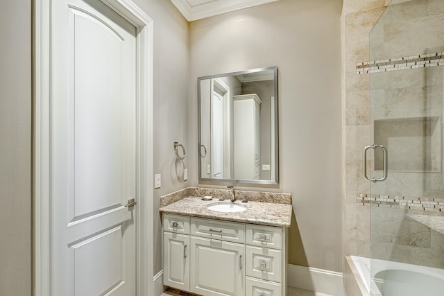 bathroom with vanity, baseboards, and bath / shower combo with glass door