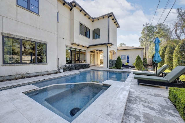 view of pool featuring a patio area and a pool with connected hot tub