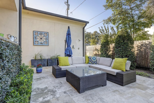 view of patio / terrace featuring outdoor lounge area and fence