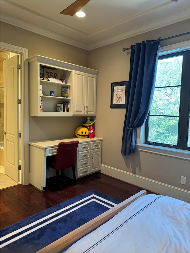 unfurnished bedroom featuring dark wood-type flooring, crown molding, and baseboards