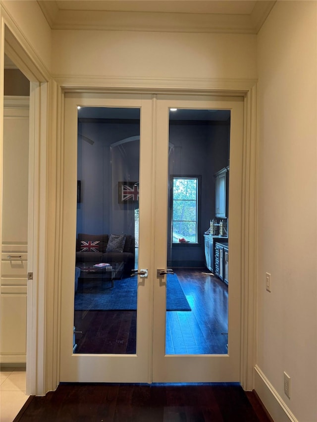 corridor with crown molding and french doors