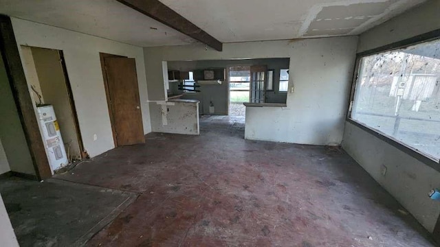 interior space with beam ceiling and water heater