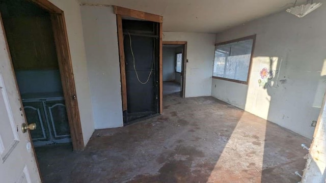 interior space with unfinished concrete flooring