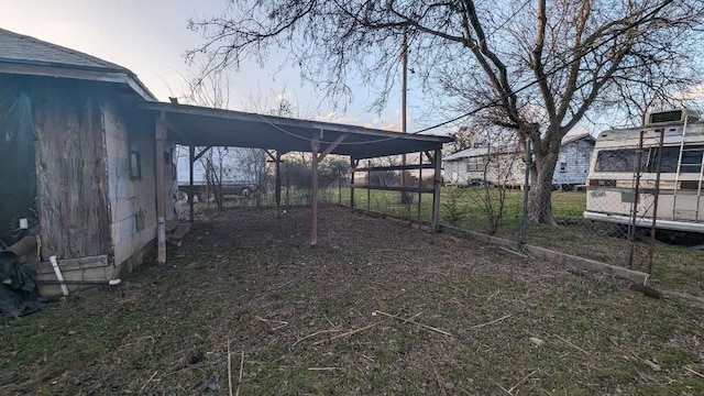 view of yard with driveway and an attached carport