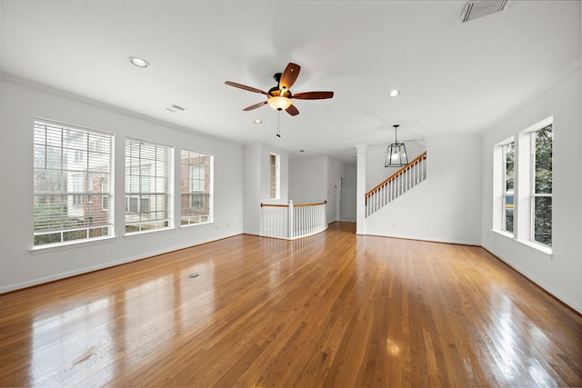 unfurnished living room featuring recessed lighting, visible vents, wood finished floors, and stairs