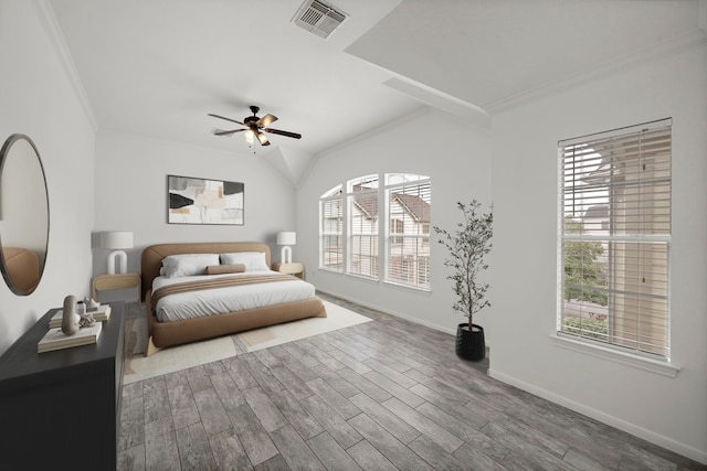 bedroom with visible vents, multiple windows, wood finished floors, and crown molding