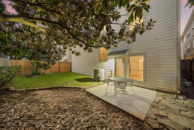 view of yard with a patio, central AC, and a fenced backyard