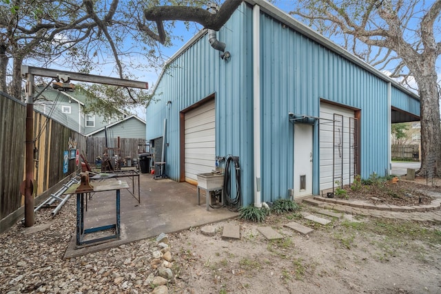 view of outdoor structure with an outbuilding and fence