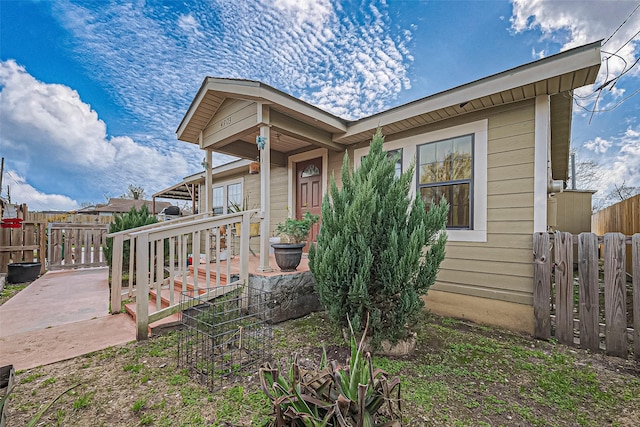 view of front of property featuring fence and a wooden deck