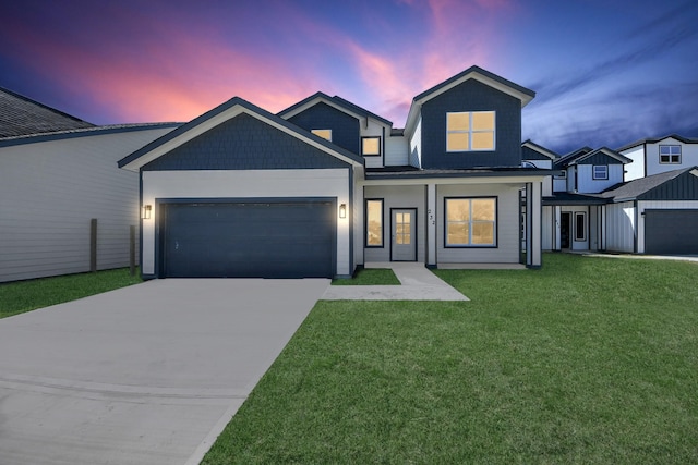 view of front of home featuring a front yard, concrete driveway, and an attached garage