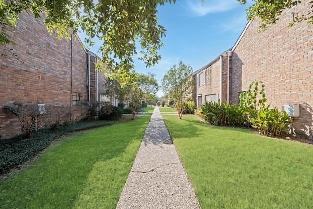 view of home's community featuring a lawn