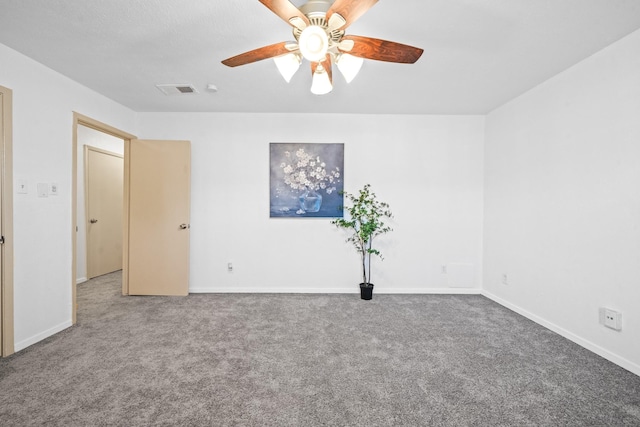 carpeted spare room with ceiling fan, visible vents, and baseboards