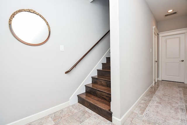 staircase with visible vents, baseboards, and marble finish floor