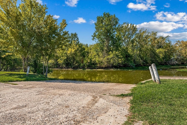 surrounding community featuring a forest view and a water view