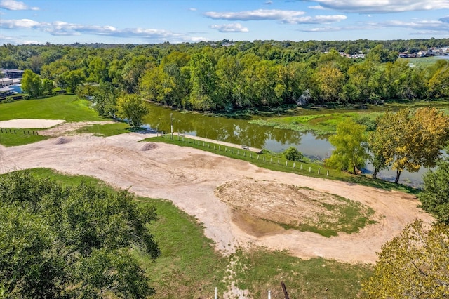 birds eye view of property with a water view and a forest view