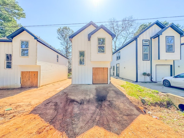 view of front of home featuring driveway, a garage, and board and batten siding