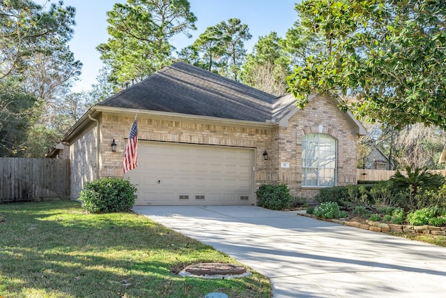 view of front of property featuring concrete driveway, roof with shingles, an attached garage, fence, and brick siding